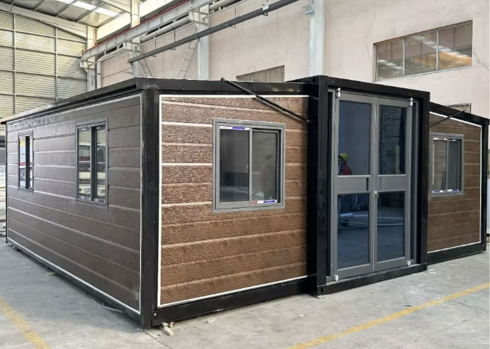 Dark timber modular container home with black frame