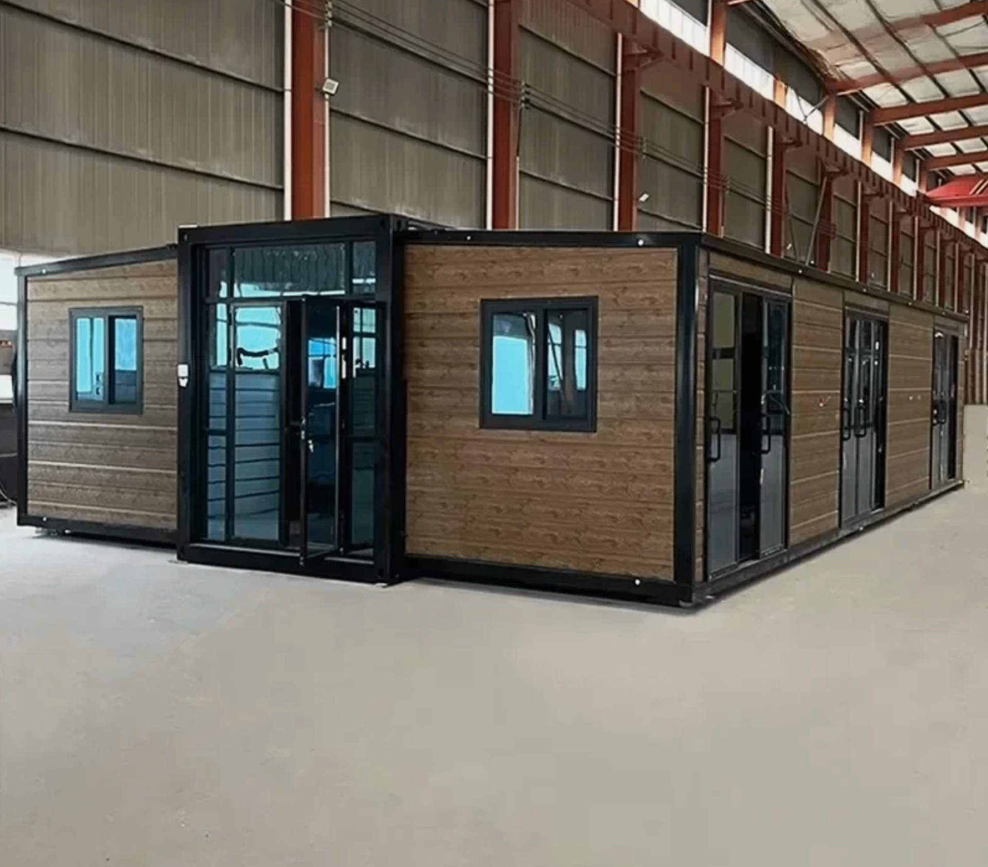 Wide brown modular container home with glazed entrance